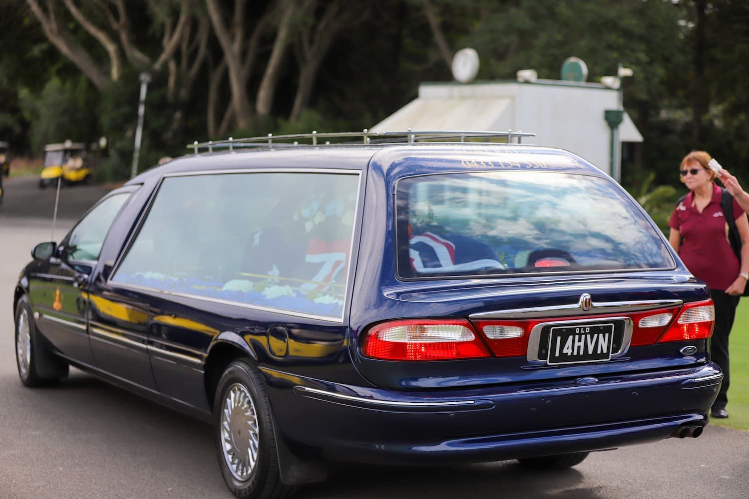 A blue car with a license plate that says 14hvn - Funeral Services in Upper Coomera, QLD