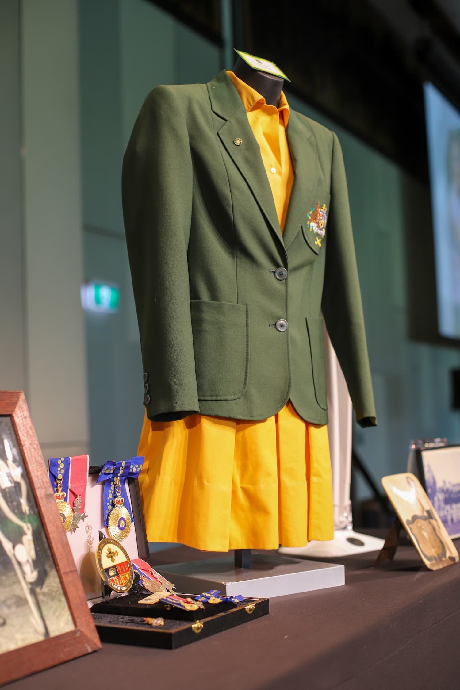 A green jacket and a yellow skirt are on display - Funeral Services in Upper Coomera, QLD