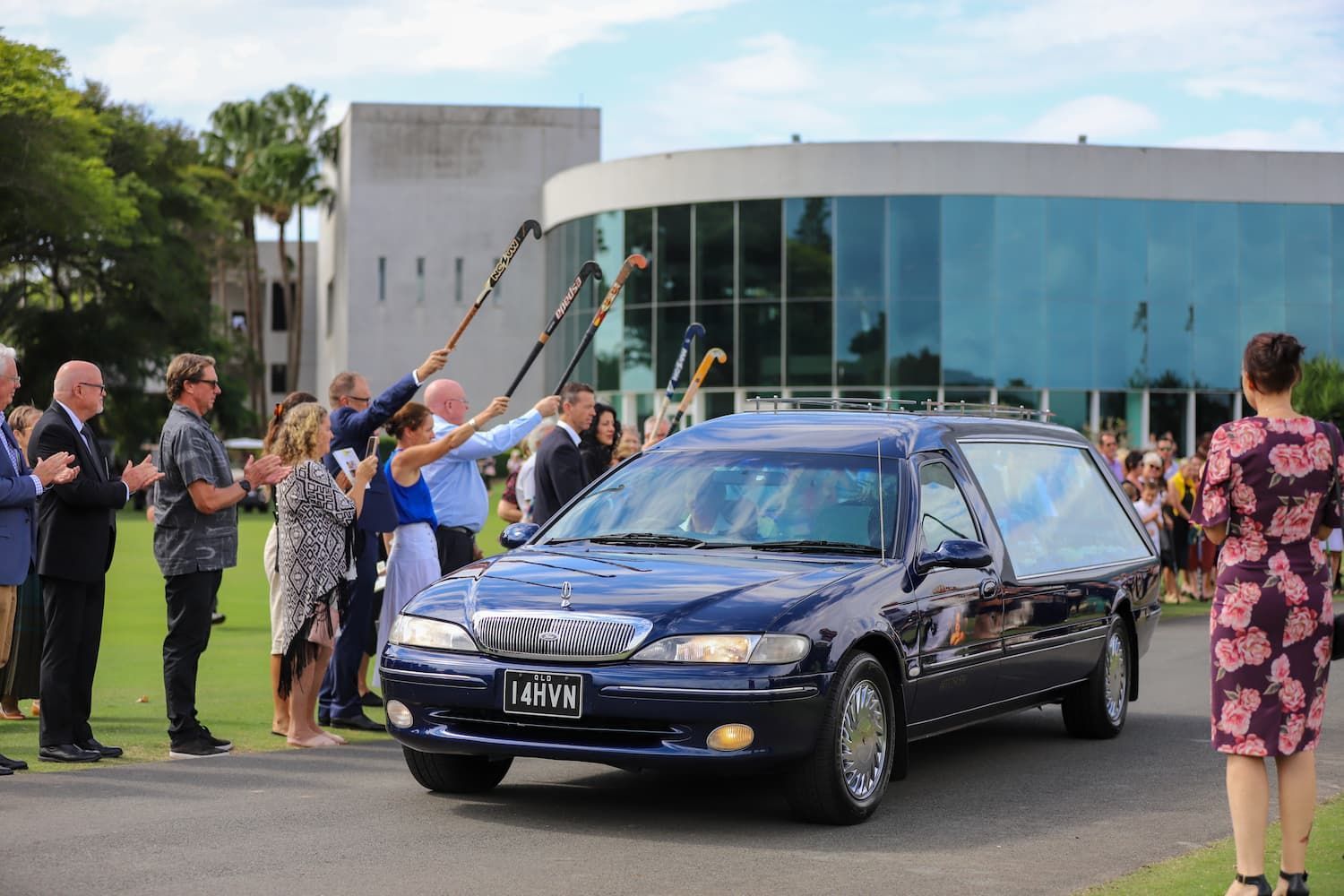 A blue car with a license plate that says 14hvn - Funeral Services in Upper Coomera, QLD