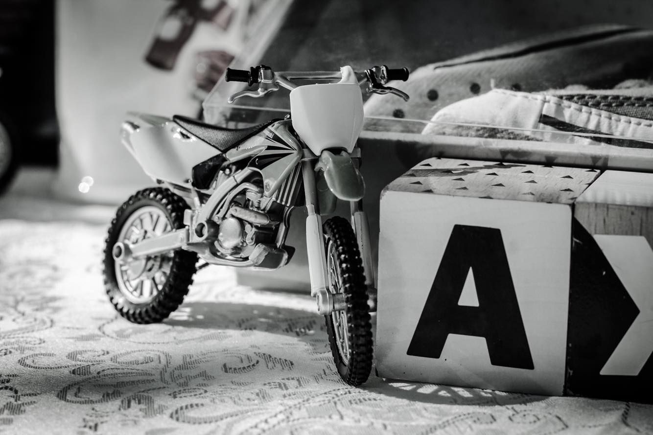 A toy dirt bike sits next to a block with the letter a on it - Funeral Services in Upper Coomera, QLD