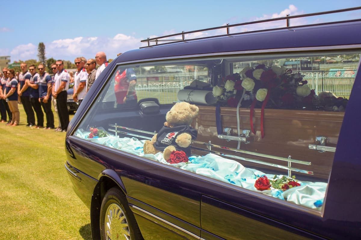 A teddy bear wearing a shirt that says i love you - Funeral Services in Upper Coomera, QLD