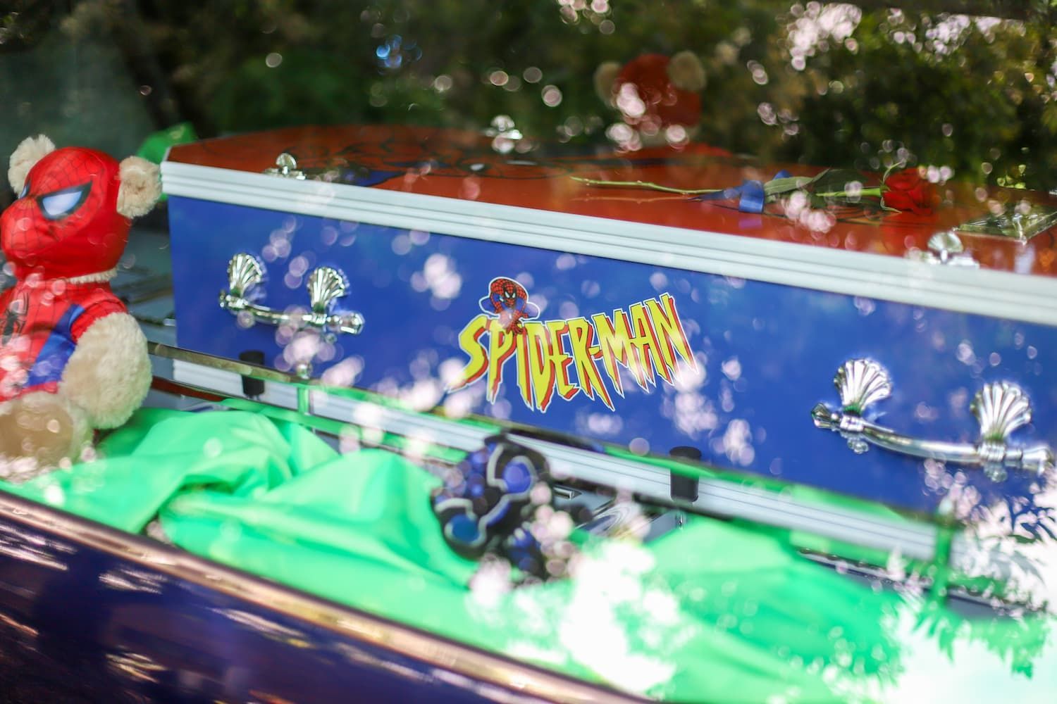 A spiderman coffin with a teddy bear in it - Funeral Services in Upper Coomera, QLD