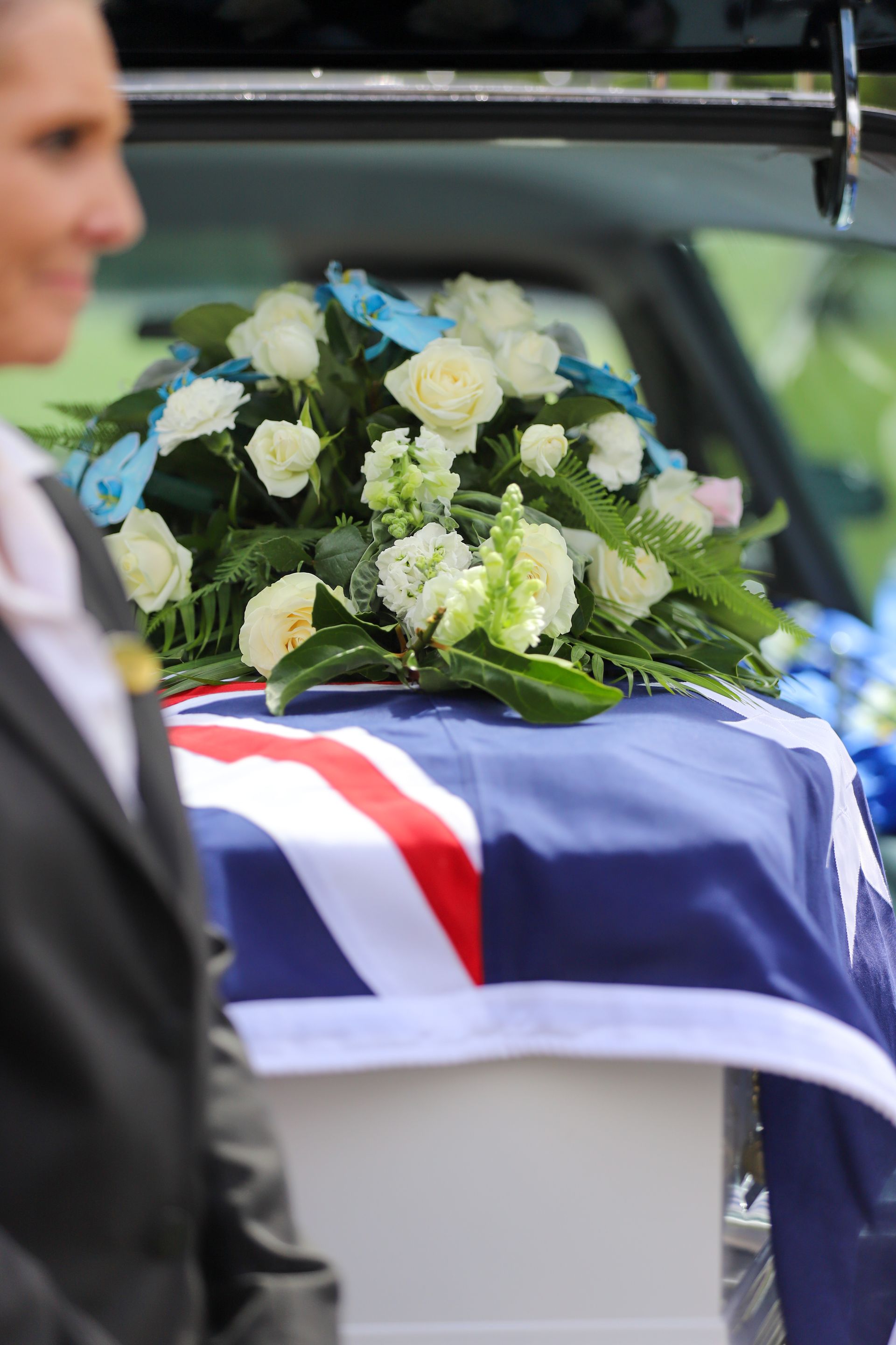 A motorcycle helmet sits on top of a wooden coffin - Funeral Services in Upper Coomera, QLD
