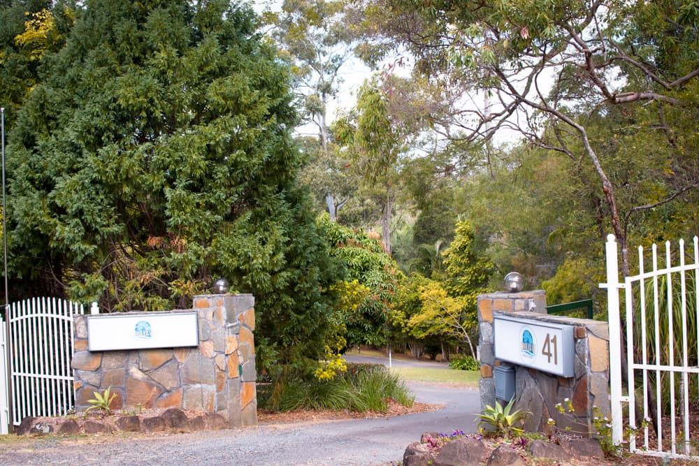 A stone wall with a sign that says ' a ' on it - Funeral Services in Upper Coomera, QLD