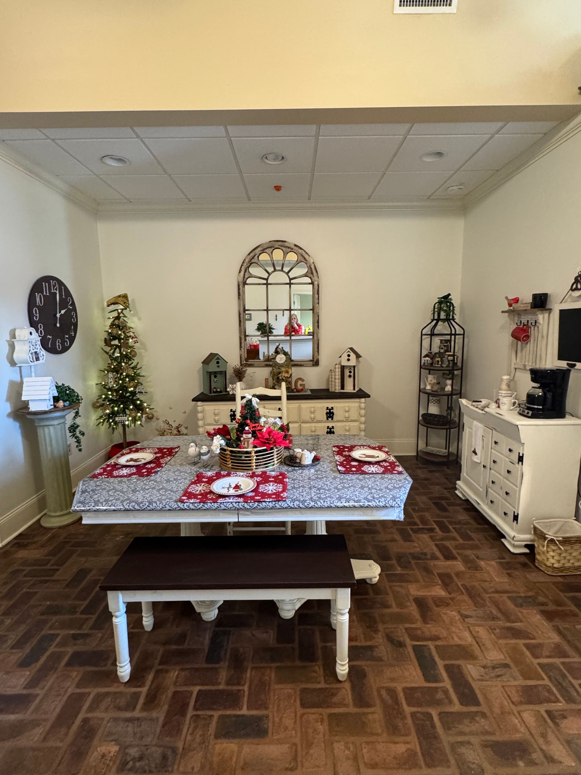 A nurse is helping an elderly woman with a cane in a nursing home.