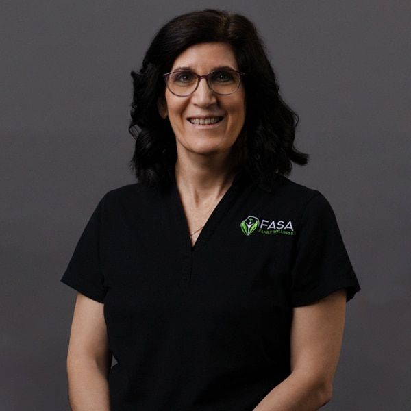 Man with beard, wearing a black polo with FASA logo, smiling at the camera.