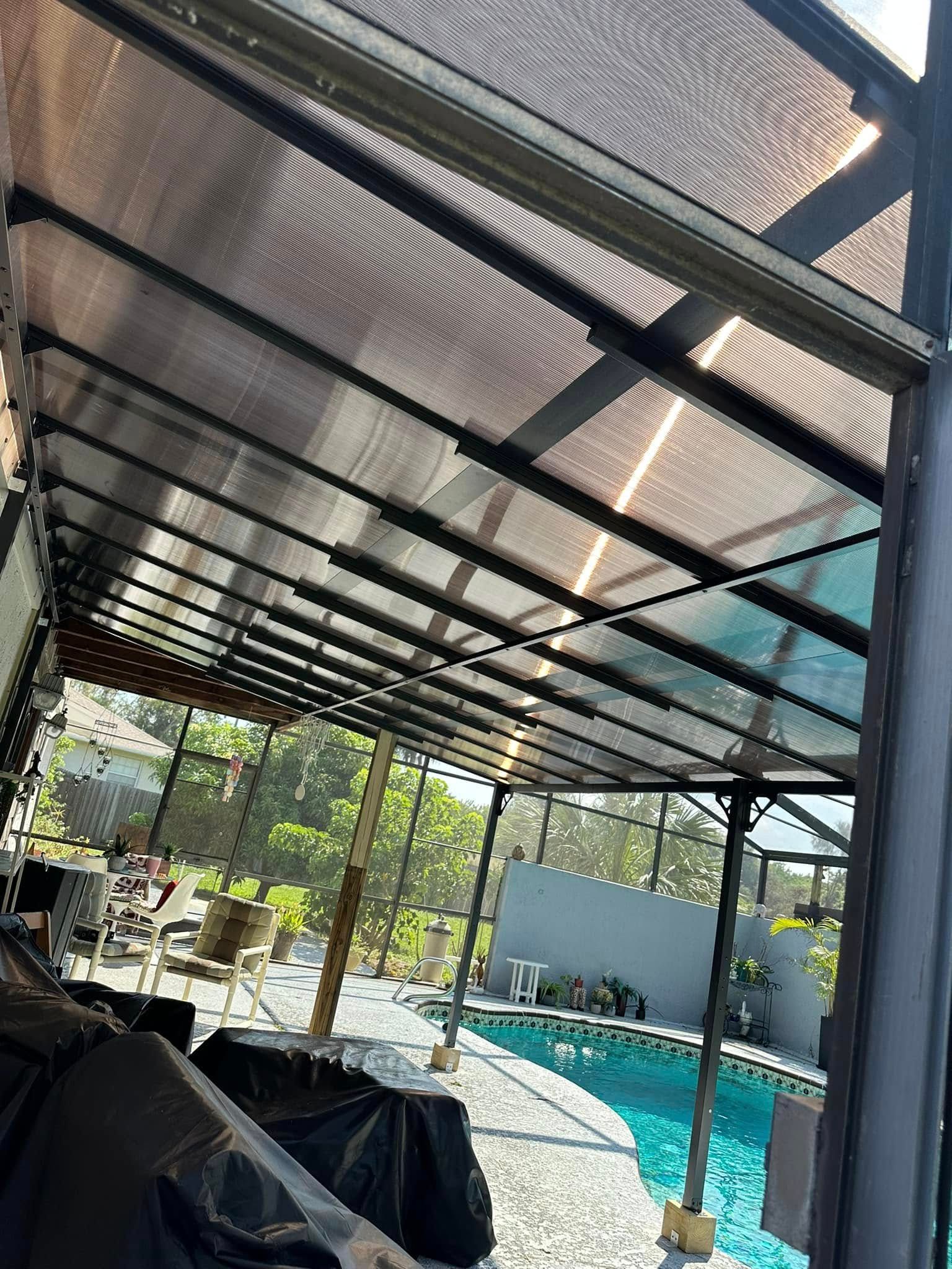 Overhead view of a pool area with a covered patio structure. The roof is translucent.