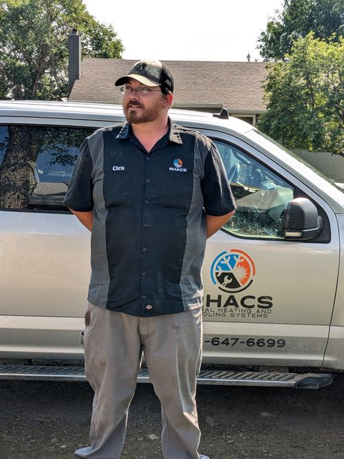 A man standing in front of a van that says rhace