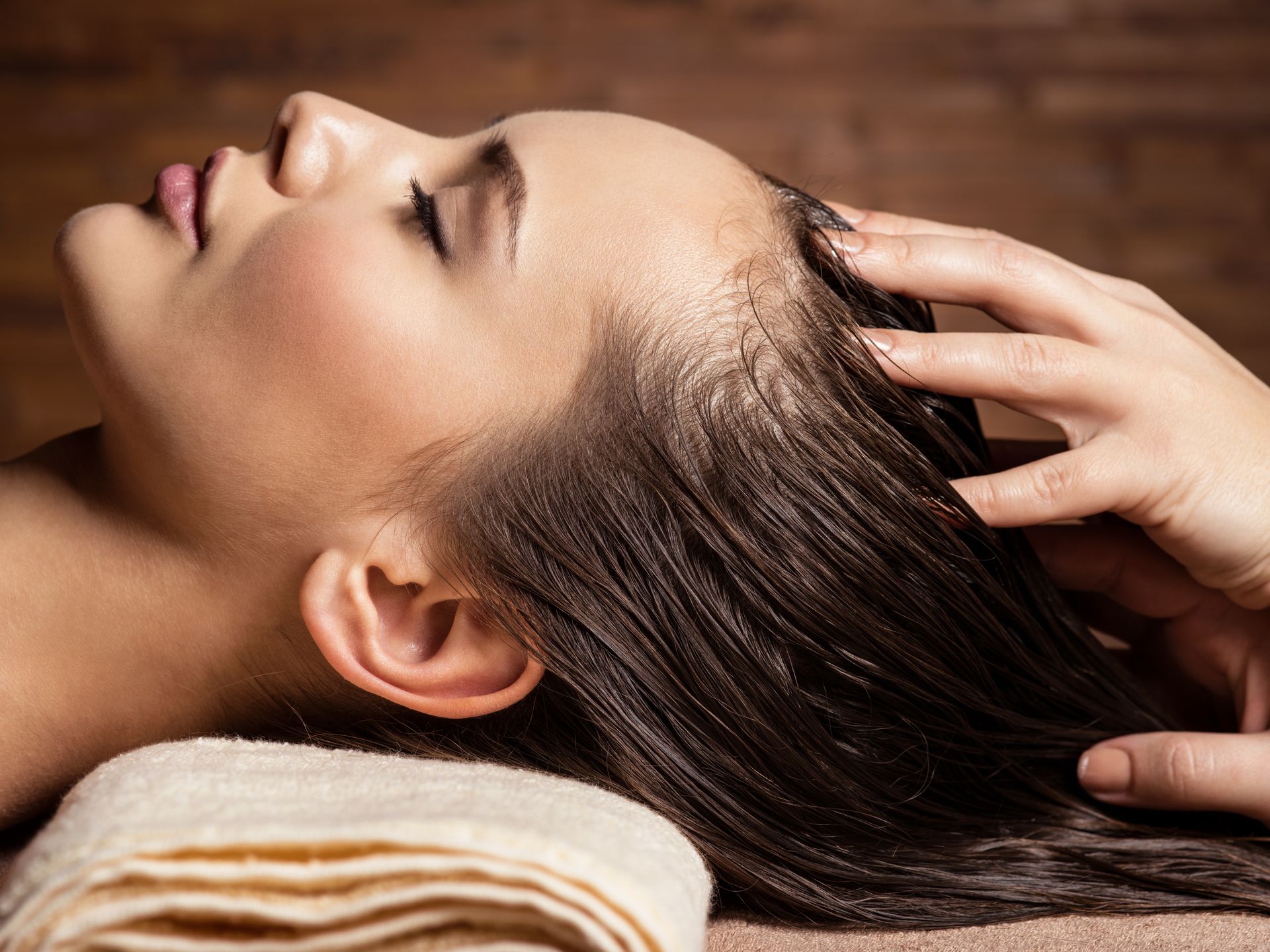 woman receiving scalp guasha massage treatment