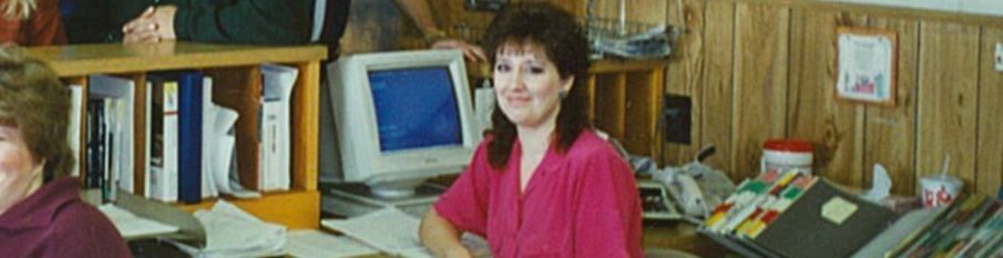 young female sitting at computer desk