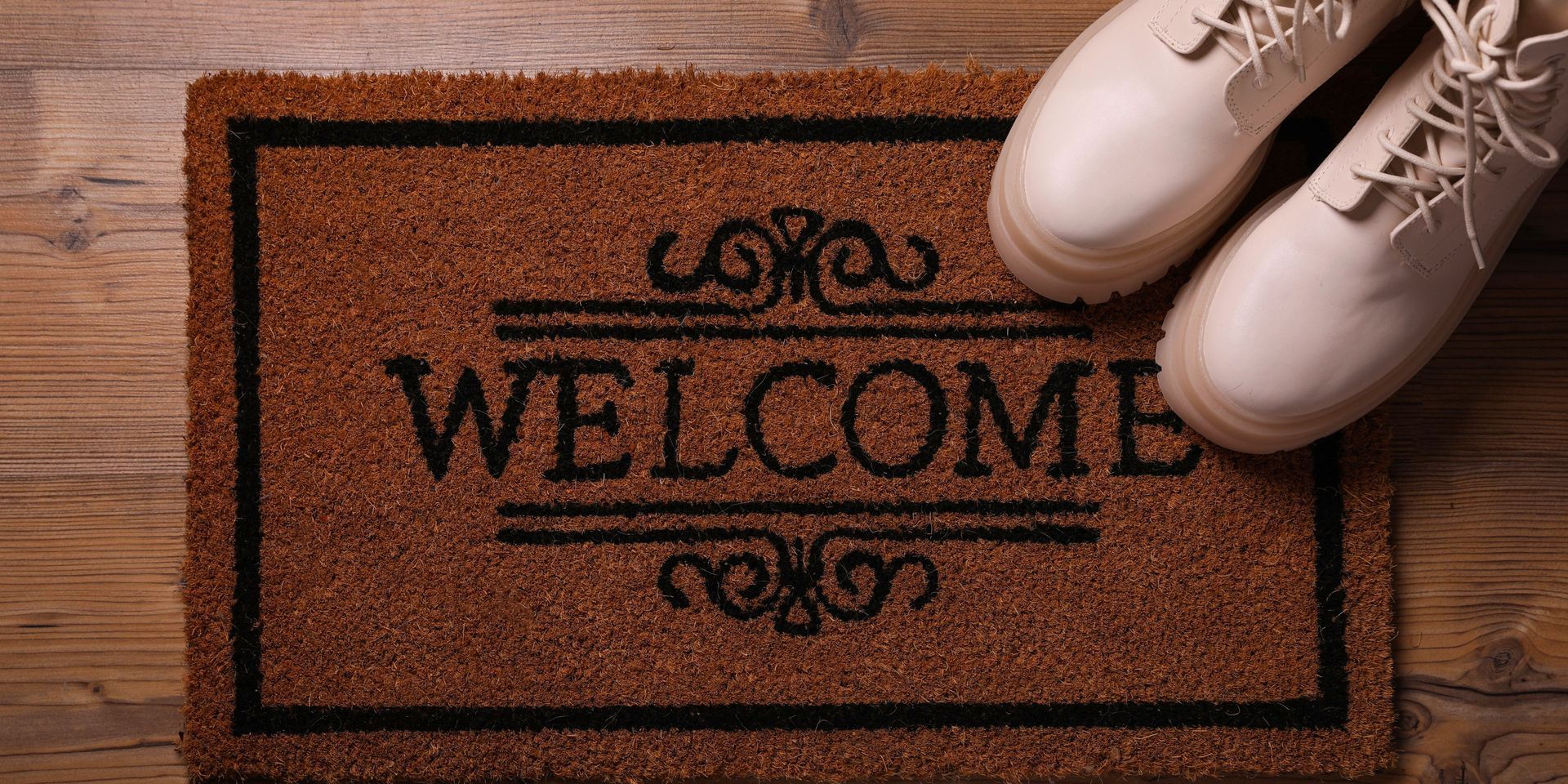 Brown welcome mat with the word 