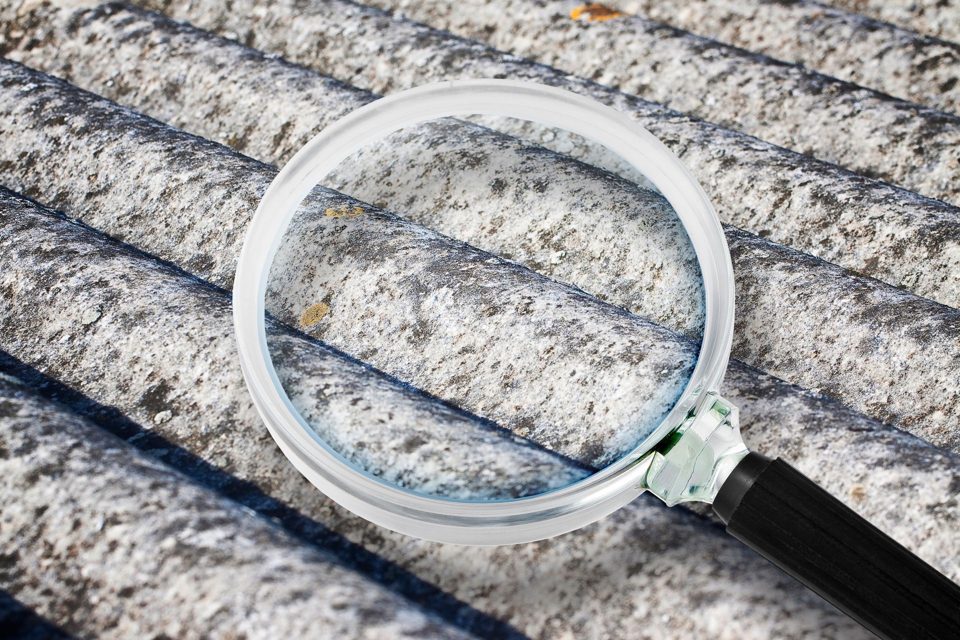 Analysis of the compounds of a dangerous asbestos roof panels with magnifying glass.