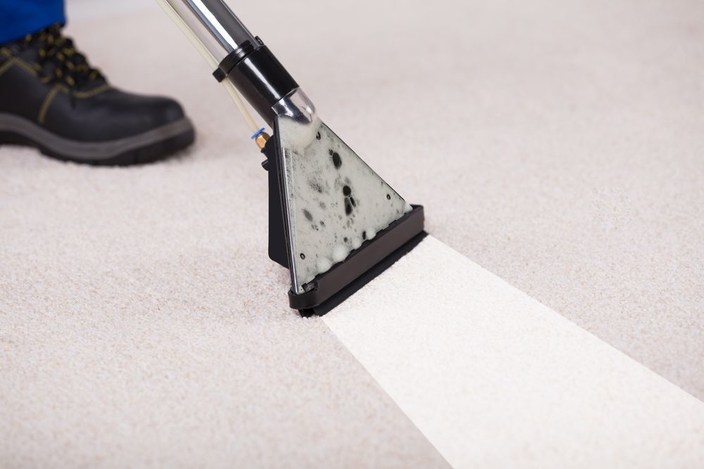 A Person Using Vacuum Cleaner for Floor Cleaning — Carpet Cleaning in Bowen, QLD