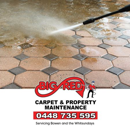 A Person Is Cleaning A Stone Wall With A High Pressure Washer — Big Red Carpet & Property Maintenance In Bowen, QLD