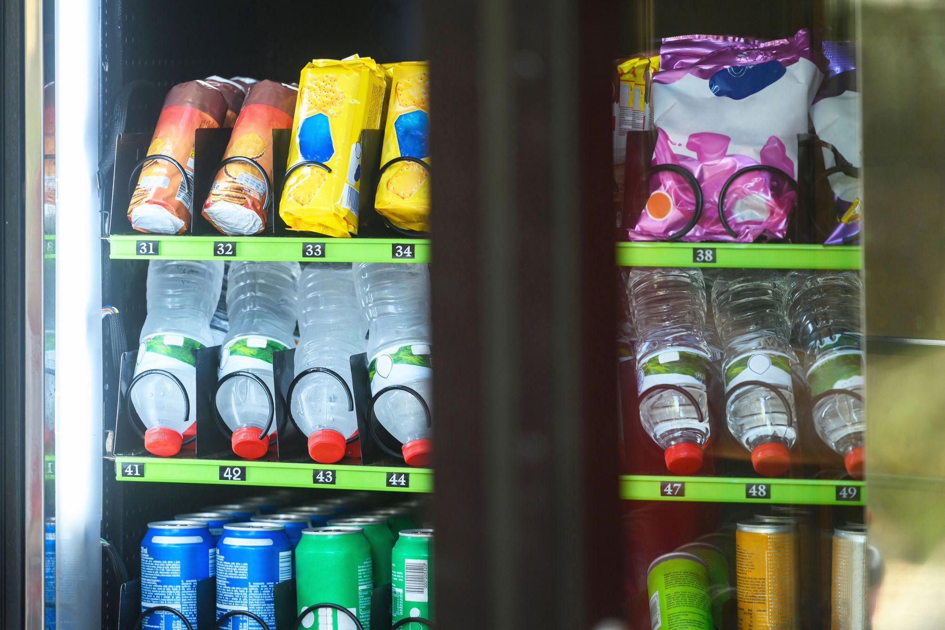 Vending machine with snacks (candy, chips) and drinks (bottled water, soda).