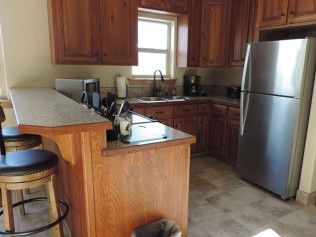 A kitchen with stainless steel appliances and wooden cabinets.