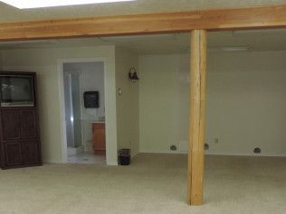 There is a wooden beam in the middle of the room.