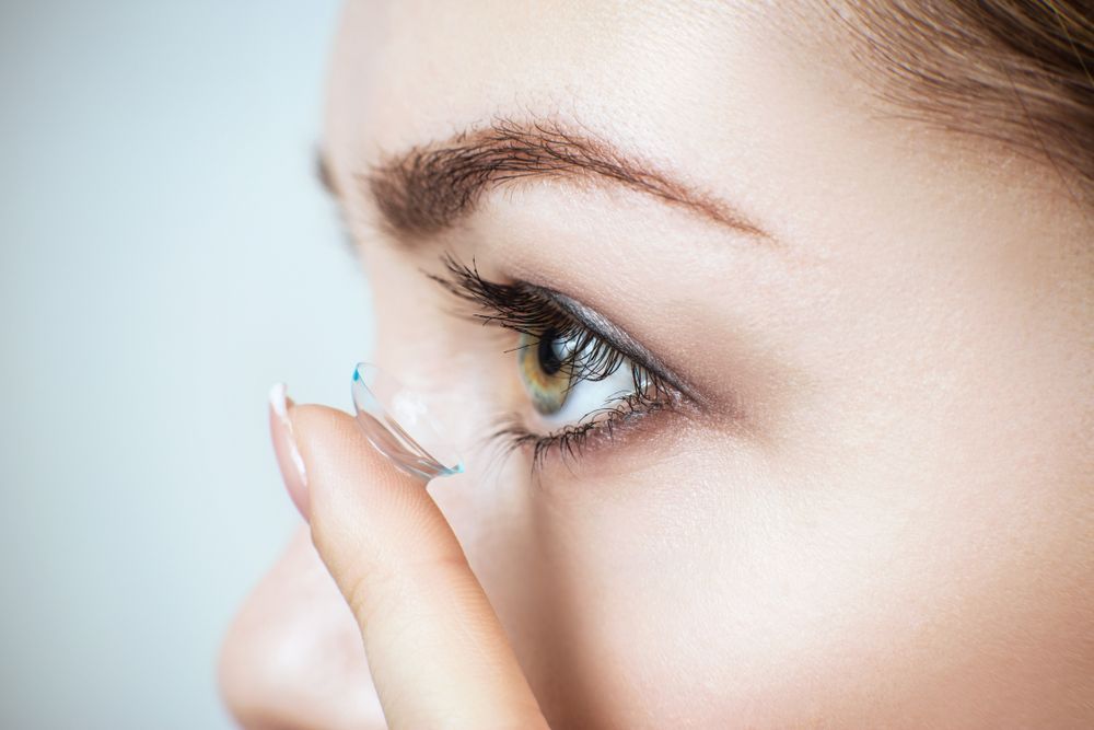 A Woman Is Putting a Contact Lens in Her Eye — New Look Eyewear In Maitland, NSW