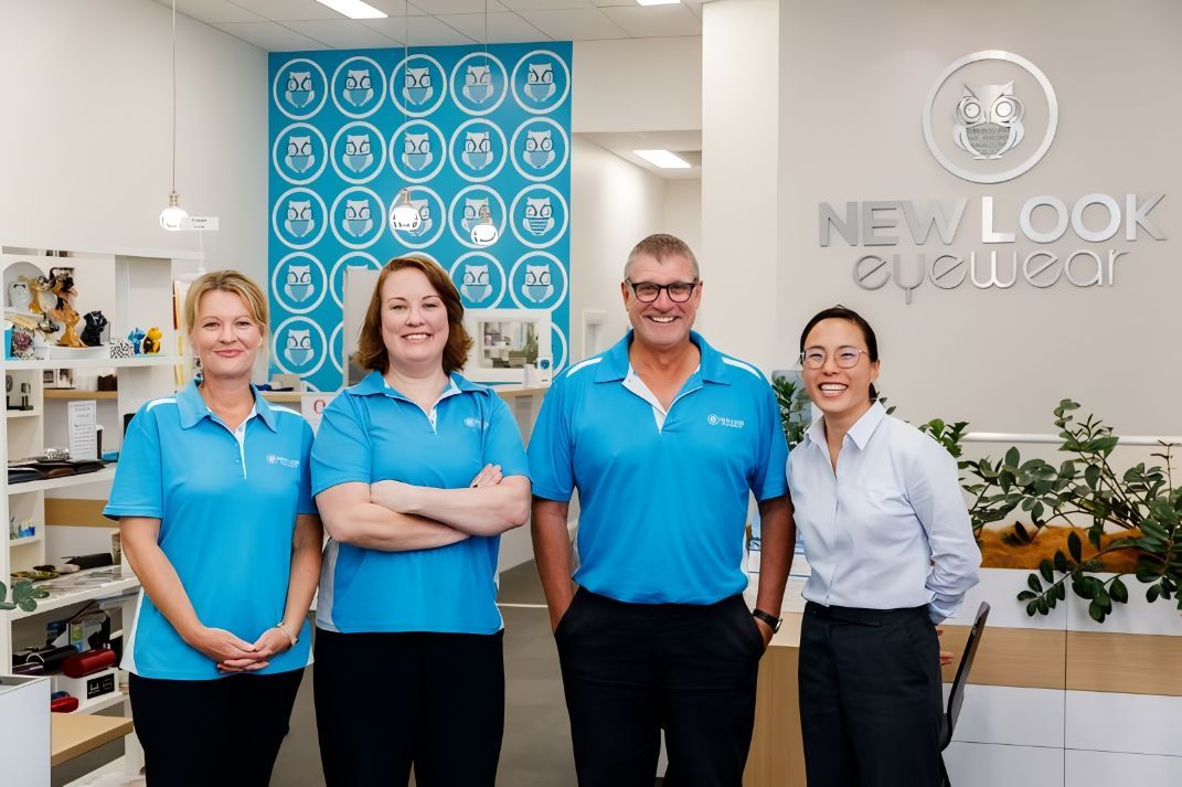 A Group of People Are Posing for A Picture in A Store — New Look Eyewear In Maitland, NSW