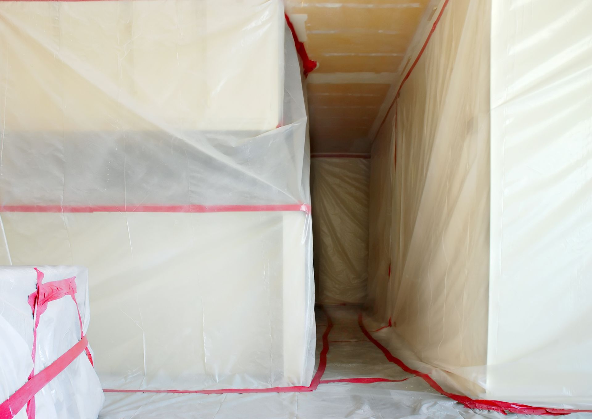 A room with a lot of plastic covering on the walls and floor.