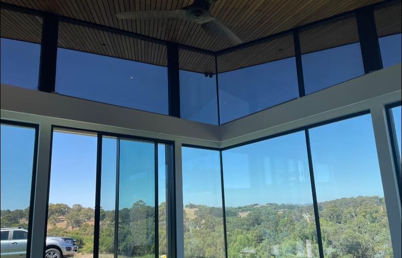 A Room With A Lot Of Windows And A Ceiling Fan – Adelaide, SA - Sola Bloc Window Tinting