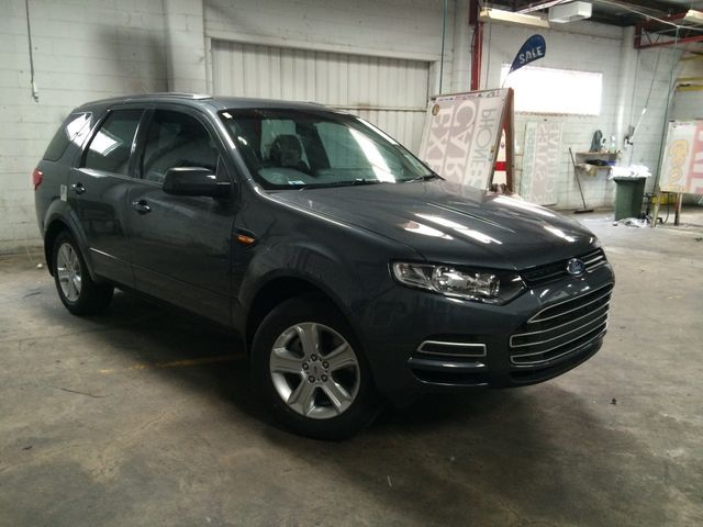 A Gray SUV Is Parked In A Garage Next To A White Wall – Adelaide, SA - Sola Bloc Window Tinting