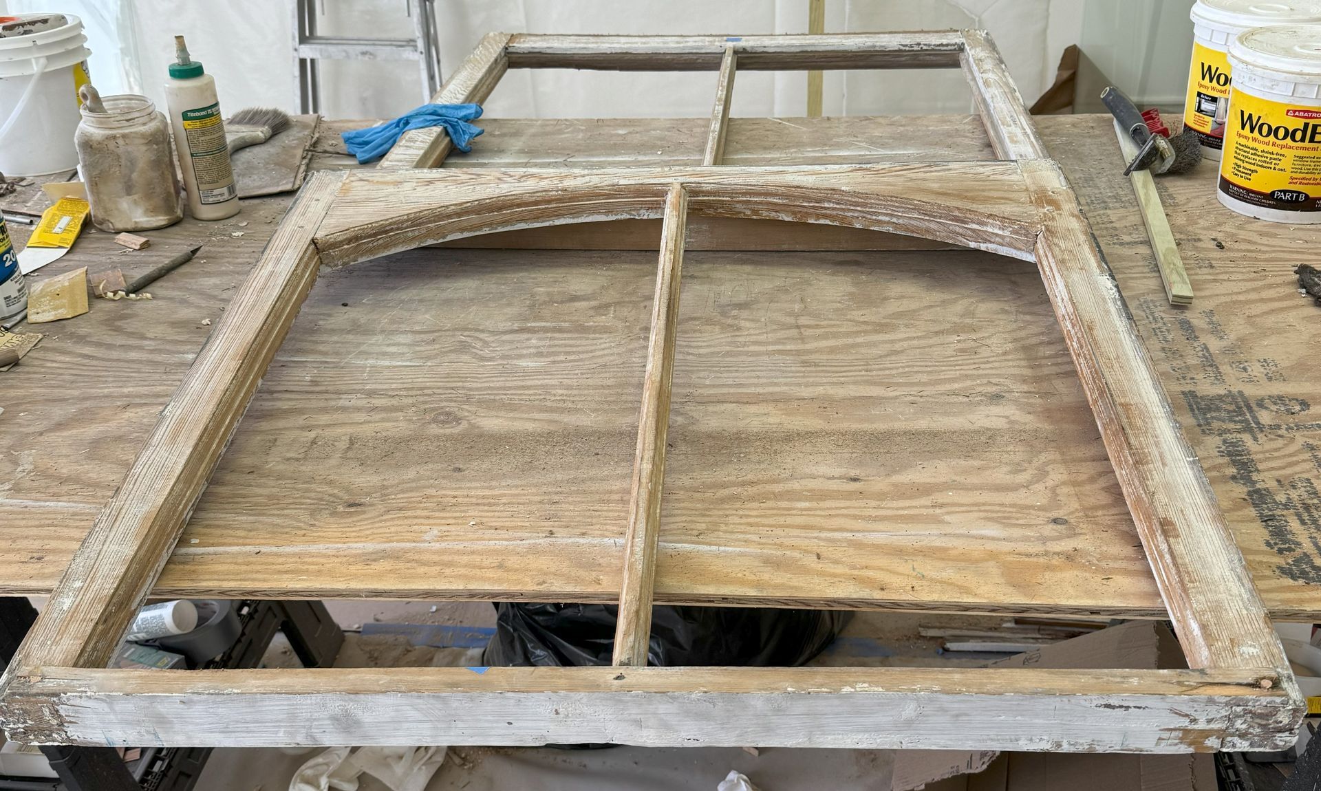 A wooden frame is sitting on top of a wooden table.