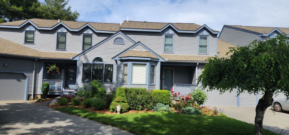 Nkomo Painting & Contracting | A large house with a tree in front of it