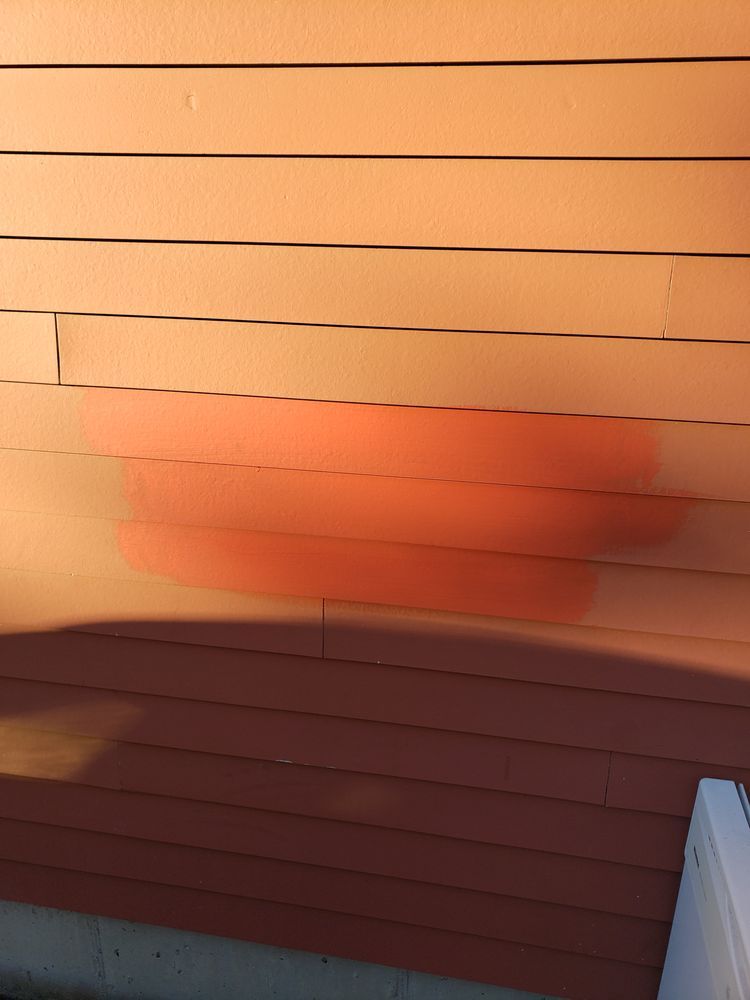 Nkomo Painting & Contracting | A close up of a red siding on a house.