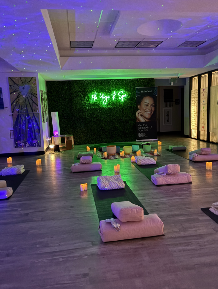 A large room filled with yoga mats and candles.