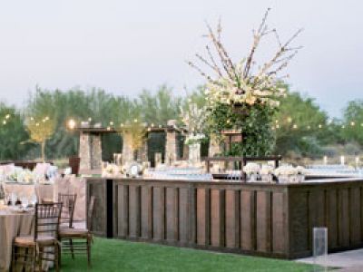 A wooden bar is sitting on top of a lush green field.