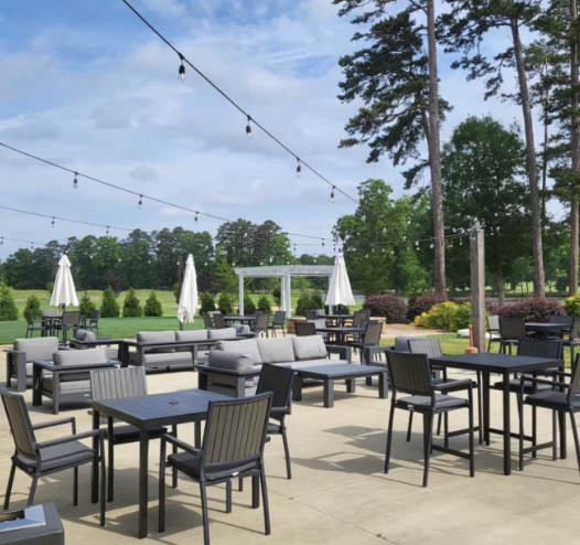 A patio area with tables and chairs and umbrellas