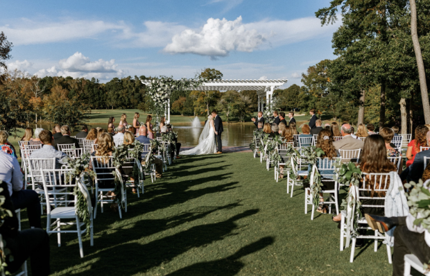 A bride and groom are walking down the aisle at a wedding ceremony.