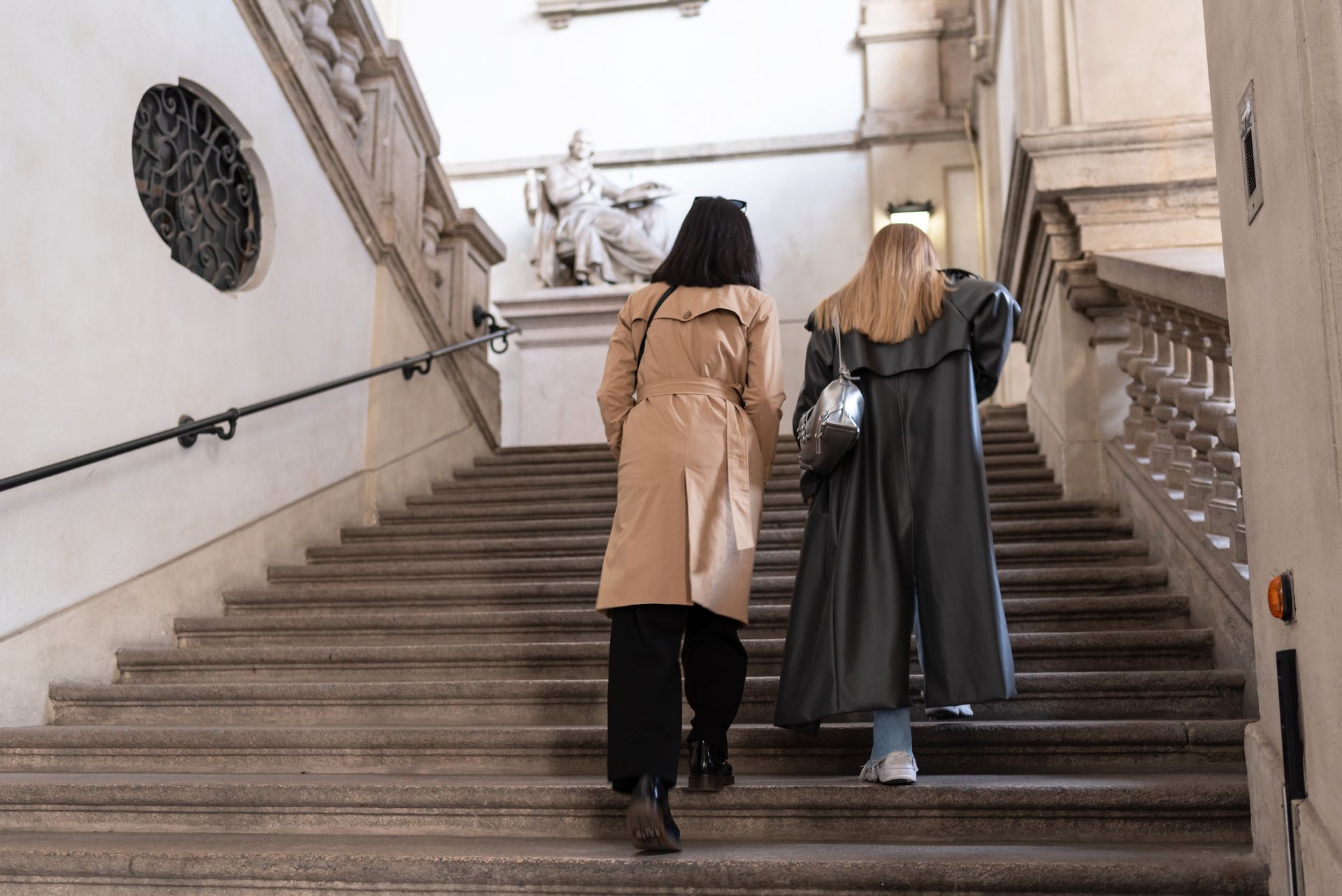 Two women are walking up a set of stairs.