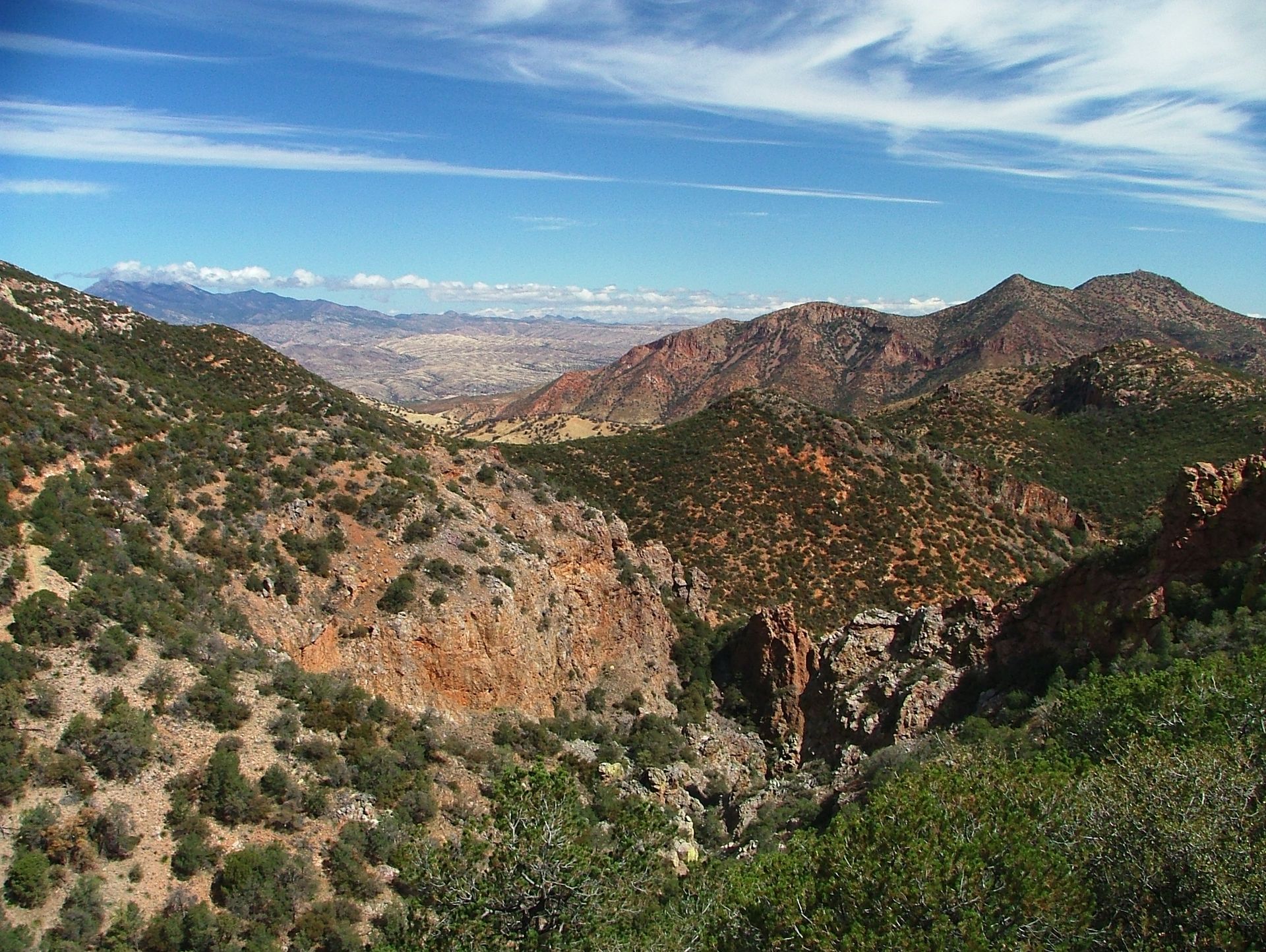 A view of a valley with mountains in the background