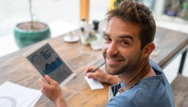 Owner of small business smiles after signing up for outsourced bookkeeping