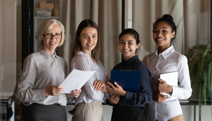 Team of bookkeeping experts smile as they promote efficient outsourced bookkeeping