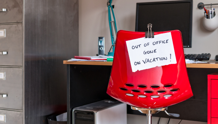 Out of office sign posted on desk chair for PTO state laws