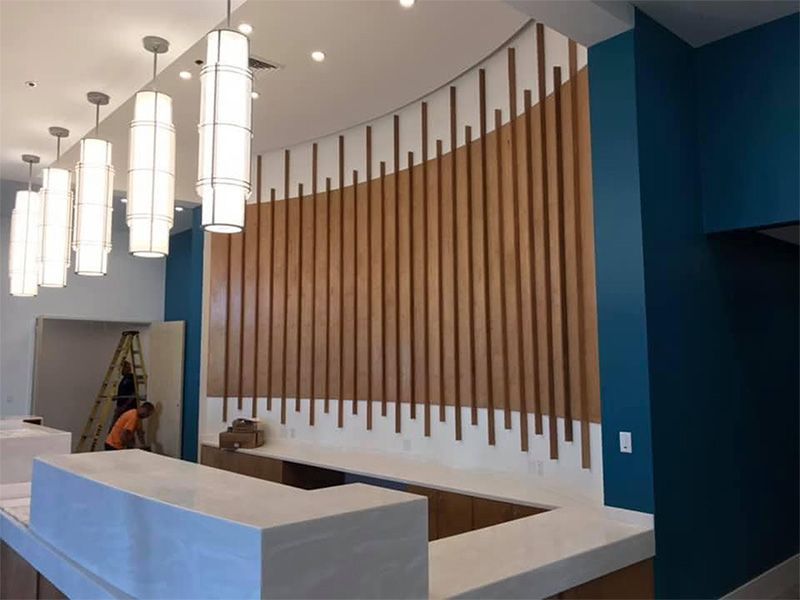 A reception area with a wooden wall and a counter
