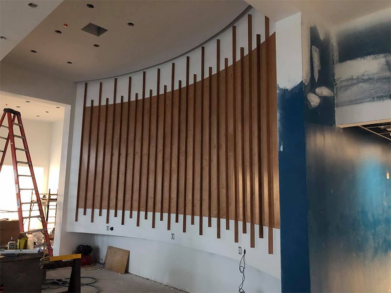 A room with a ladder and a wooden wall