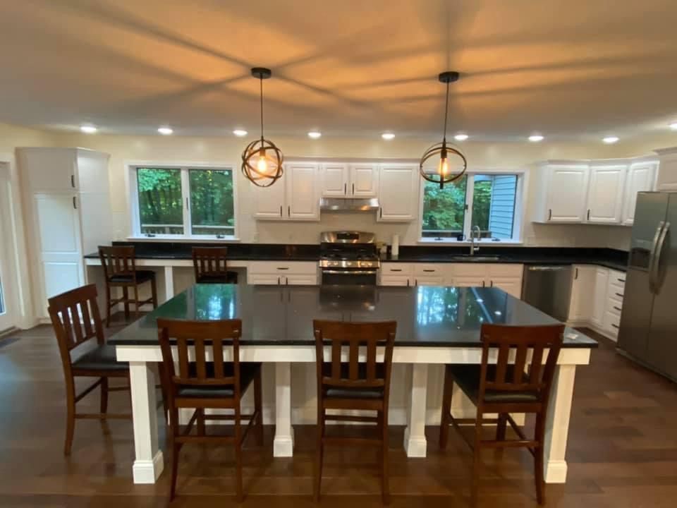 A kitchen with a table and chairs in it