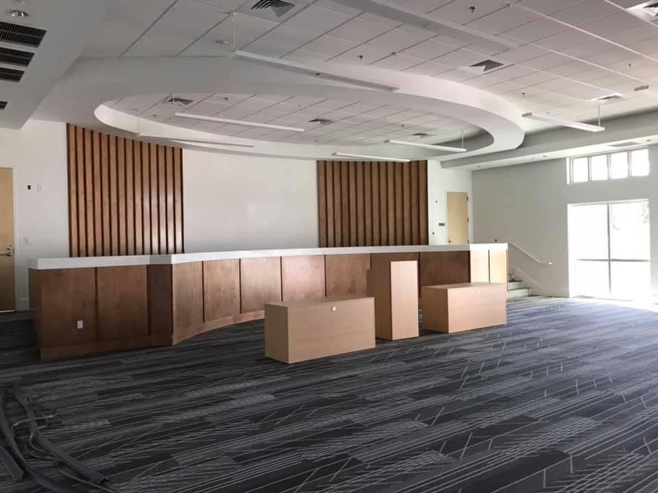 A large empty room with boxes on the floor.