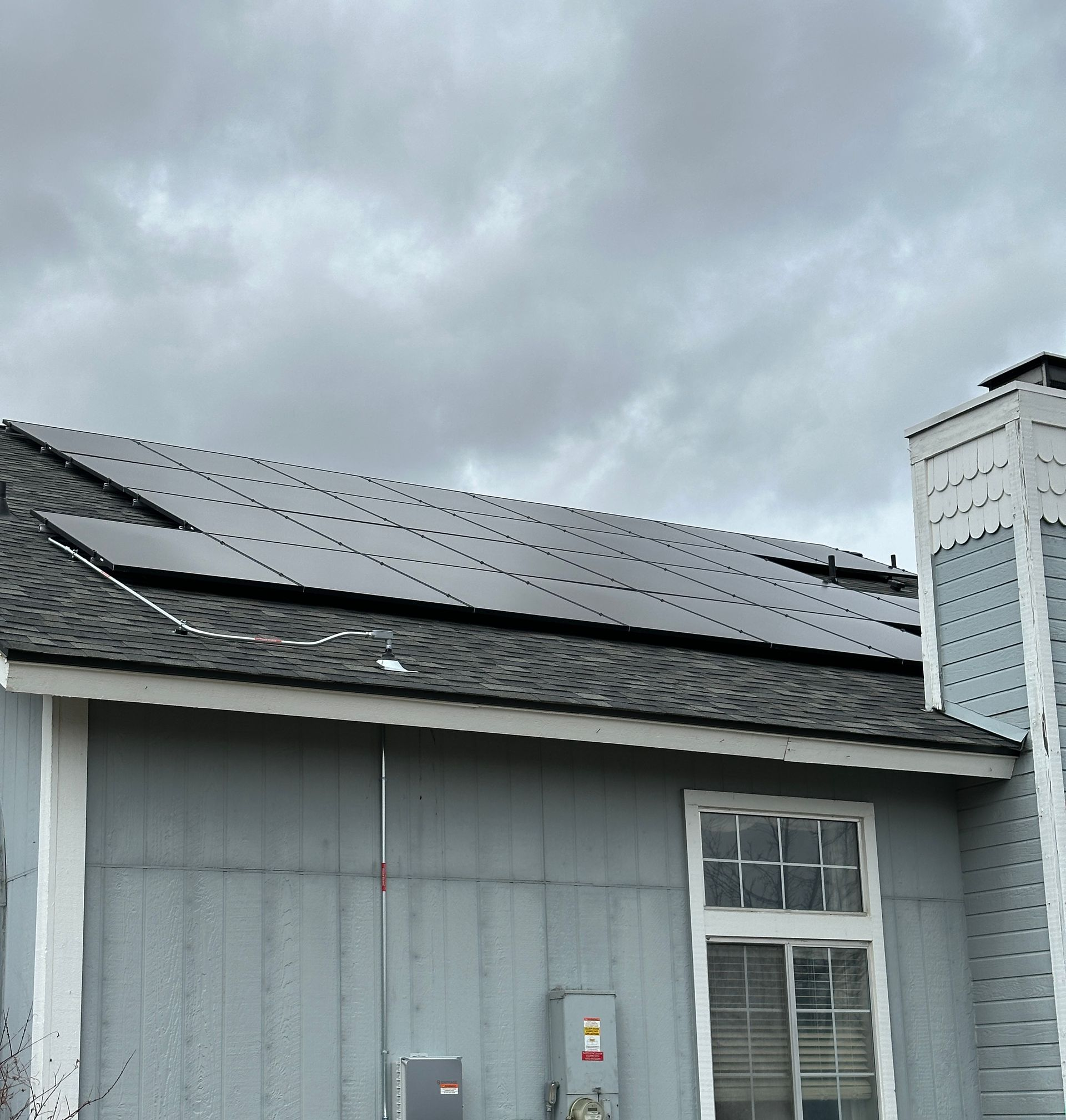 A white house with solar panels on the roof
