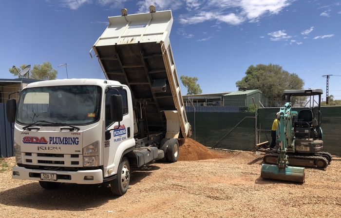 A Heavy Duty White Tipper Truck — SDA Plumbing in Alice Springs NT