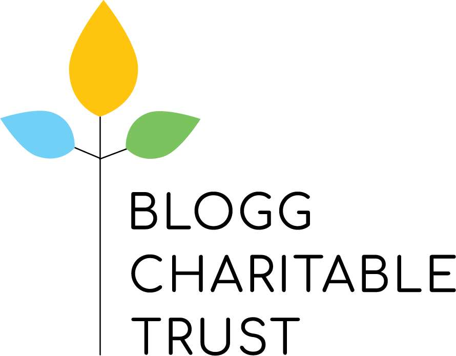 The logo for blogg charitable trust is a tree with leaves on it.