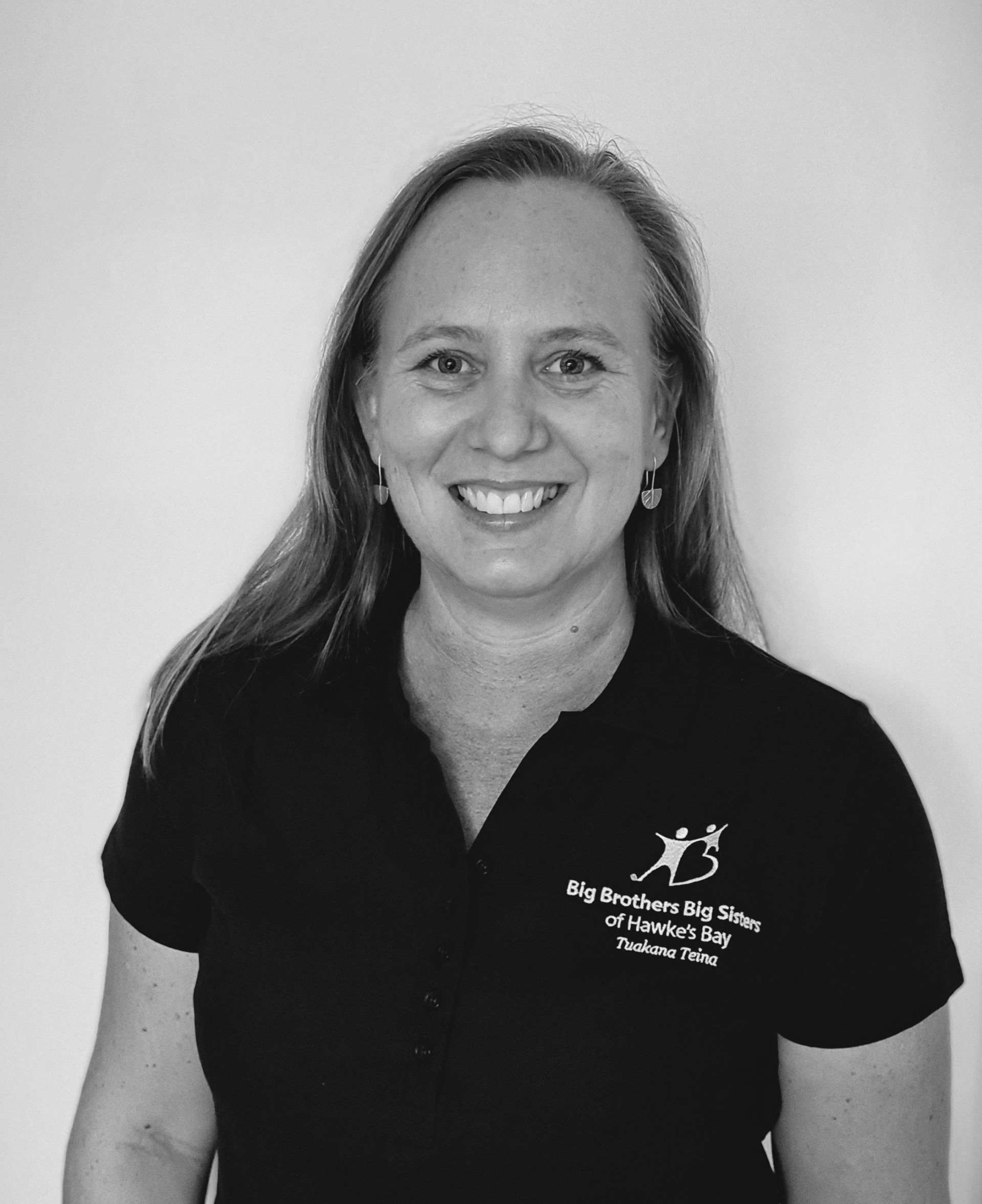 A black and white photo of a woman wearing a black shirt