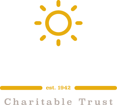 The logo for the charitable trust is a sun with rays coming out of it.