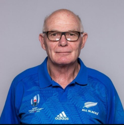 A man wearing glasses and a blue adidas shirt
