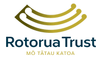 The logo for rotorua trust is a gold and blue swirl.