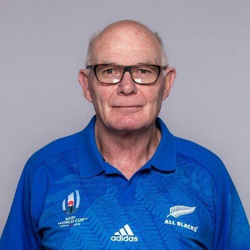 The man is wearing glasses and a blue shirt.